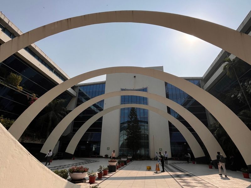 The STPI Chennai directorate: concentric white arches framing the building entrance, with people walking beneath them